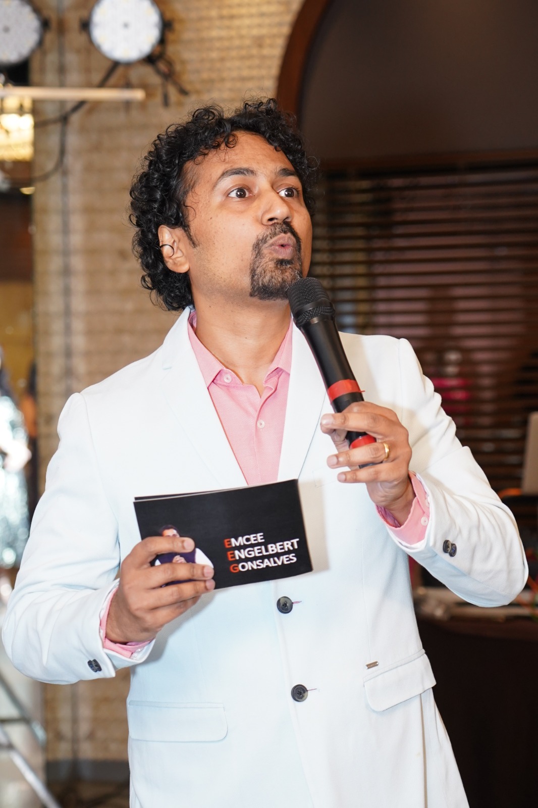 Emcee mid-speech with microphone