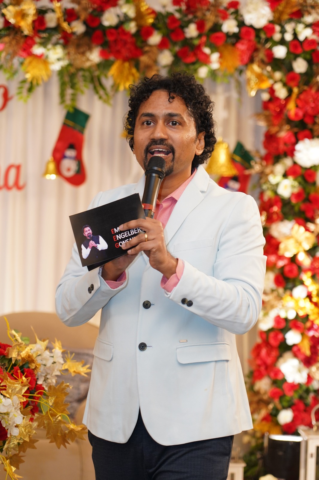 Emcee against floral event backdrop